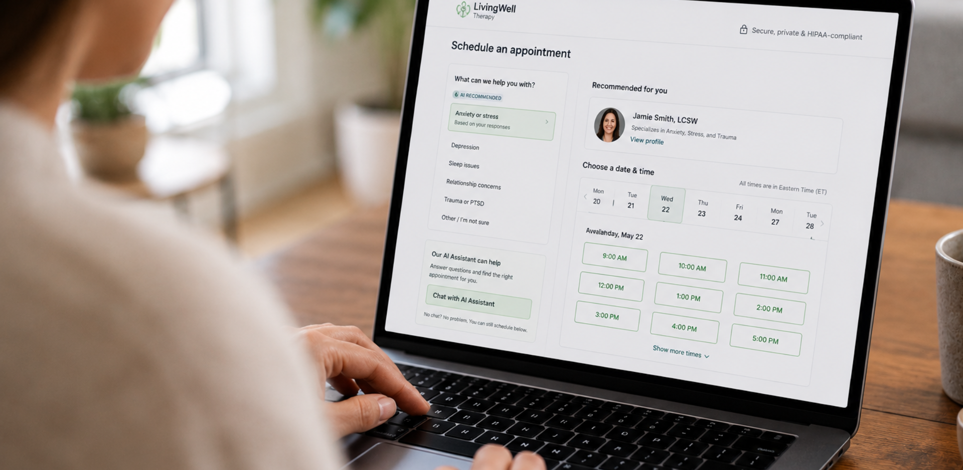Person using a laptop to schedule a healthcare appointment through an AI-assisted, HIPAA-compliant platform.